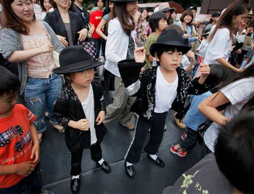 Japanese fans dance to mark the first death anniversary of pop legend Michael Jackson, in Tokyo Saturday, June 26, 2010.