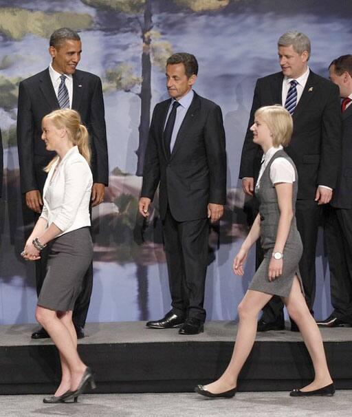 United States President Barack Obama (L), France`s President Nicolas Sarkozy (C) and Canada`s Prime Minister Stephen Harper take part in a photo opportunity between G8 leaders and the