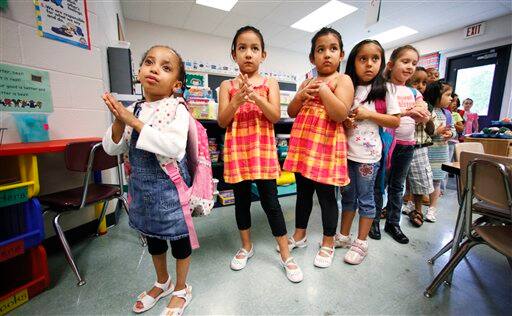 AUG. 16 AND THEREAFTER ** This photo taken Wednesday, July 29, 2009 shows would be Kindergatens rubbing hand sanitizer on their hands before going to lunch at a summer school program in Montgomery County`s Brookhaven Elementary School, in Rockville, Md.