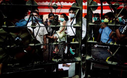 People queue up to be tested for the swine flu virus outside Naidu Hospital in Pune, India, Tuesday, Aug. 11, 2009. The country-wide death toll due to swine flu related virus has gone up to 10, a news agency reported.