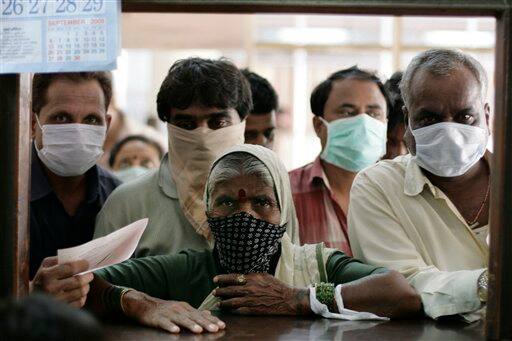 People stand at a counter to get information on swine flu at Sassoon Hospital in Pune, India, Tuesday, Aug. 11, 2009. The country-wide death toll of swine flu related deaths has risen to 10, a news agency reported.