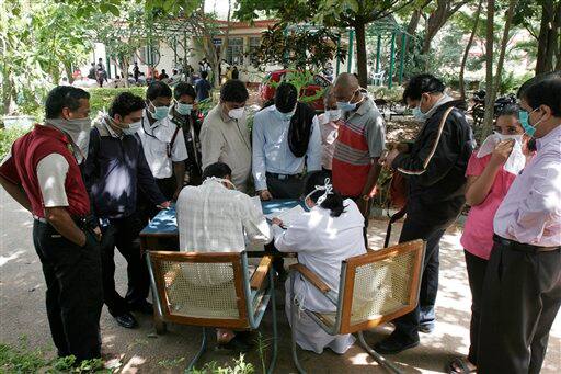 People register to get themselves examined at a swine flu examination center at a government hospital in Bangalore, India, Monday, Aug. 10, 2009. According to media reports, two more people infected with swine flu have died, raising the country`s death toll from the virus to six.