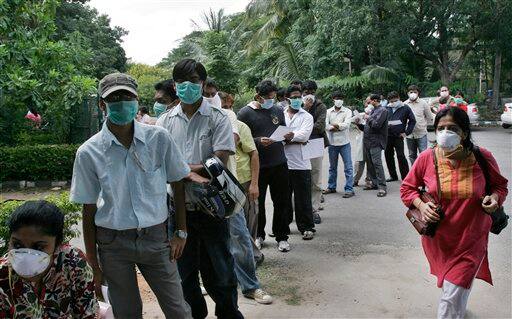 People wait in a queue to get themselves examined at a swine flu examination center at a government hospital in Bangalore, India, Monday, Aug. 10, 2009. According to media reports, two more people infected with swine flu have died, raising the country`s death toll from the virus to six.