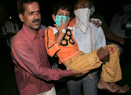 Relatives carry a young boy to be tested for swine flu at Kasturba Gandhi hospital in Mumbai, India, Saturday, Aug. 8, 2009. A woman infected with swine flu died at a private hospital Saturday, becoming the country`s second fatality related to the virus.