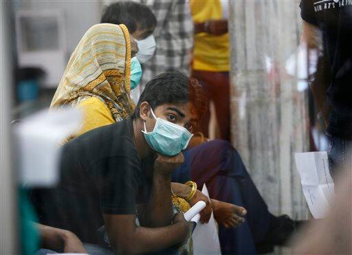 Patients wait to get themselves examined at a H1N1 Swine flu examination center at a government hospital in New Delhi, India, Sunday, Aug. 9, 2009. Media reports say three more people infected with swine flu have died in India, raising the country`s death toll related to the virus to four.