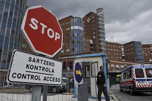 A security guard control the access at Cruces Hospital in Barakaldo, northern Spain, Monday, April 27, 2009