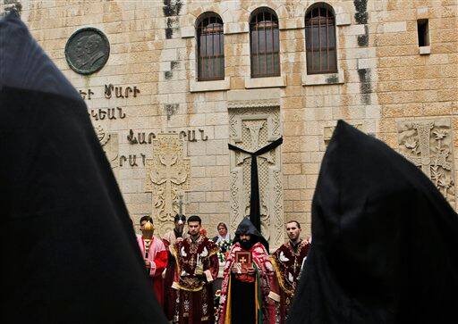 Armenian clergy take part in a prayer marking the 94th anniversary of the mass killing of the Armenian people, at a monument next to St. James Cathedral in the Armenian Quarter of Jerusalem`s Old City