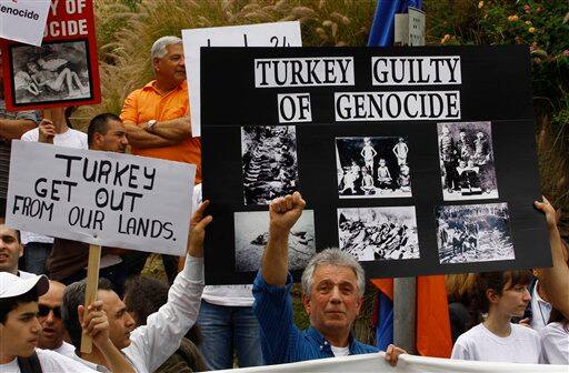 Armenian protesters gather during a rally marking the 94th anniversary of the mass killing of the Armenian people in front of the Turkish Embassy in Tel Aviv, Israel.