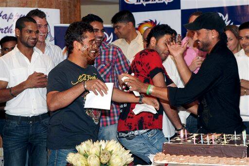 Indian cricketer Sachin Tendulkar, second left wearing black, celebrates his 36th birthday with teammates Harbhajan Singh, right, and Yuvraj Singh, second right, in Durban