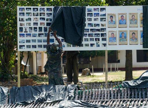 Sri Lankan soldiers prepare a display consisting of arms captured from Tamil Tiger rebels in Killinochchi about 230 kilometers (143 miles) north east of Colombo, Sri Lanka, Friday