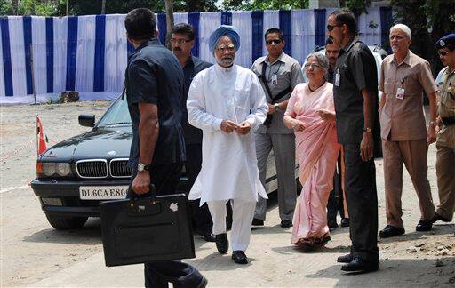 Manmohan Singh, accompanied by wife Gursharan Kaur, arrives to cast his vote.