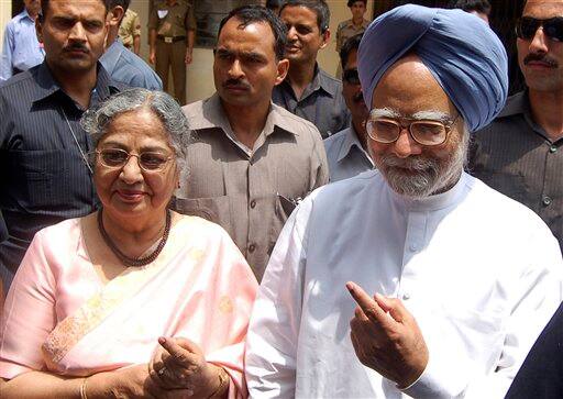 Manmohan Singh and wife Gursharan Kaur show their marked fingers to media after casting their votes.