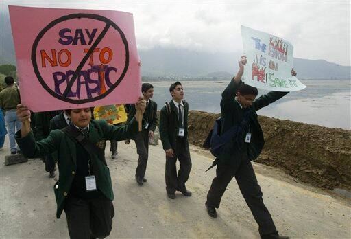 Kashmiri school children carry placards during a rally commemorating Earth Day in the outskirts of Srinagar