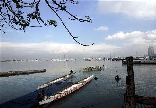 Members of a rowing team prepare to head to the shores of Manila Bay to collect garbage as the country joins the rest of the world to mark Earth Day 