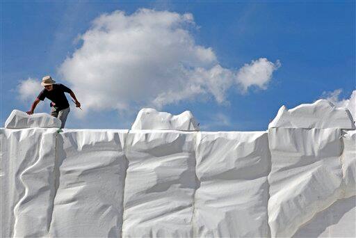 A worker sets up a fake iceberg as part of an Audi auto-car showroom  in Singapore, a tiny-city state known for its hot and wet climate all year round.