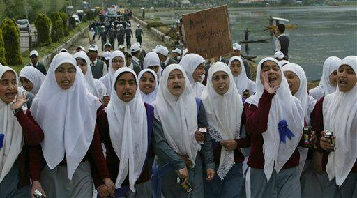 Kashmiri school children shout slogans against the use of polythene bags during a rally commemorating Earth Day in the outskirts of Srinagar