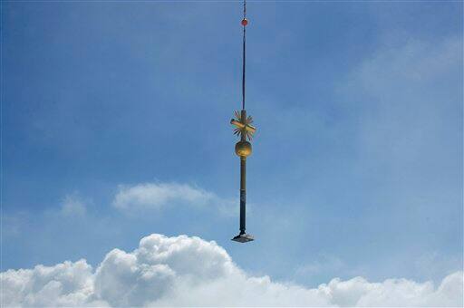 The summit cross of Germany`s highest mountain, Zugspitze near Garmisch-Partenkirchen, southern Germany, is transported via helicopter 