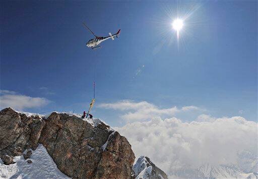 A helicopter transports the summit cross of Germany`s highest mountain, the Zugspitze near Garmisch-Partenkirchen, southern Germany.