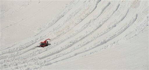 A snow crawler moves snow for the Zugspitz glacier on the Zugspitz plateau near the mountain Zugspitze (2,962 meter), southern Germany.