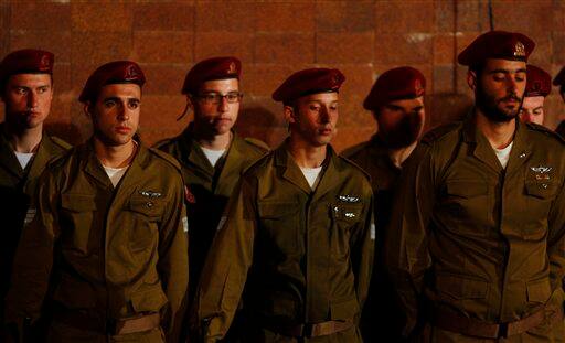 Israeli soldiers solemnly stand during the opening ceremony marking the Holocaust Remembrance Day at Yad Vashem Holocaust Memorial in Jerusalem, Israeli Prime Minister Benjamin Netanyahu pledged Monday that there will be no second Holocaust against the Jewish people, speaking on the annual memorial day for the 6 million Jewish victims of the Nazis in World War II.