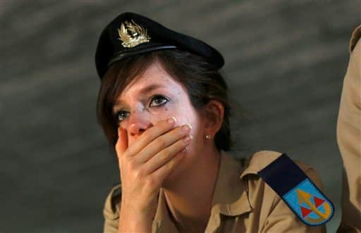 A female Israeli soldier reacts during a ceremony in the Hall of Remembrance at the Yad Vashem Holocaust Memorial in Jerusalem, Tuesday, April 21, 2009. Frenetic Israel came to a standstill for two mournful minutes on Tuesday as air-raid sirens pierced the air in remembrance of the 6 million Jews who perished in the Nazi Holocaust.