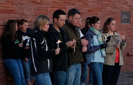 Family and friends gather at a candlelight vigil at the Columbine High School memorial at Clement Park, near Littleton, Colo., on Sunday, April 19, 2009. Monday marks the 10th anniversary of the shooting at the school where a teacher and 12 students were killed.