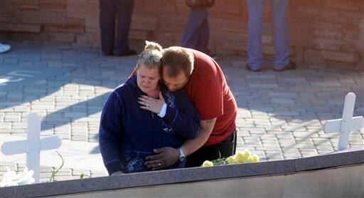 Brynn and David Gustafson read the inscriptions at the Columbine High School memorial at Clement Park, near Littleton, Colo., on Sunday, April 19, 2009, prior to a candlelight vigil on the eve of the 10th anniversary of the massacre.