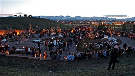 Family and friends gather for a candlelight vigil at the Columbine High School memorial at Clement Park, near Littleton, Colo., on Sunday, April 19, 2009. Monday is the 10th anniversary of the shooting at the school where a teacher and 12 students were killed.