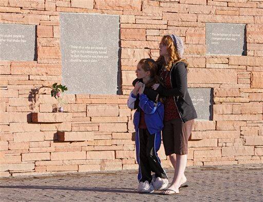 Madeline Abram, 13, and her sister Bella, 9, of Parker, Colo., visit the Columbine High School Memorial at Clement Park, near Littleton, Colo., on Sunday, April 19, 2009. Monday is the 10th anniversary of the shooting at Columbine.