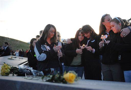 Family members of slain Columbine High School teacher Dave Sanders attend a candlelight vigil at the Columbine Memorial at Clement Park near Littleton, Colo., on Sunday, April 19, 2009. From left are niece Julia Bernzott, granddaughter Mallory Sanders, stepdaughter Coni Sanders, stepdaugher Cindy Thirouin, granddaughter Tiffany Strole.