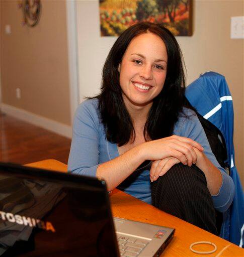 Kristi Mohrbacher, 26, a survivor of the shootings at Columbine High School 10 years ago, takes time out from her work at her home in Denver, Colo., on, Wednesday, April 16, 2009. Morbacher says,