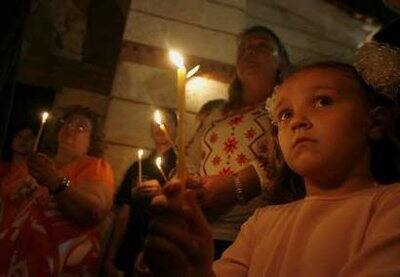 Christians hold candles during an Orthodox Easter service at the Church of the Nativity of the Lord in Havana April 18, 2009.