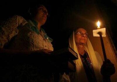 Christians hold candles during an Orthodox Easter service at the Church of the Nativity of the Lord in Havana April 18, 2009.