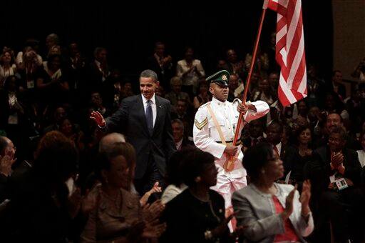 President Barack Obama waves as he arrives for the opening ceremony of the 5th Summit of the Americas on Friday, April 17, 2009 in Port of Spain, Trinidad and Tobago.