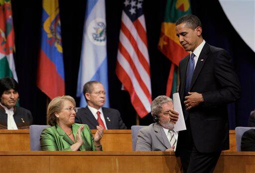 Chile`s President Michelle Bachelet applauds after President Barack Obama, walking, delivered his speech during the inauguration 5th Summit of the Americas in Port of Spain, Trinidad and Tobago, Friday April 17, 2009. At left is Bolivia`s President Evo Morales.