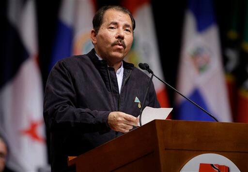 Nicaragua`s President Daniel Ortega reads a note which he said was written by Cuba`s President Raul Castro, as he delivers a speech during the opening ceremony of the 5th Summit of the Americas in Port of Spain, Trinidad and Tobago, Friday April 17, 2009.