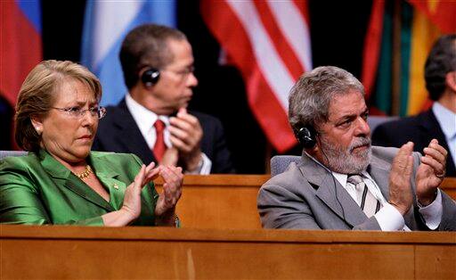 Chile`s President Michelle Bachelet, left, and Brazil`s President Luiz Inacio Lula da Silva applaud during the inauguration of the 5th Summit of the Americas in Port of Spain, Trinidad and Tobago, Friday April 17, 2009.