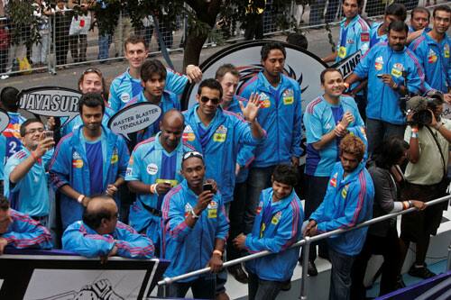 Mumbai Indians cricket team members drive past during a parade through the streets of Cape Town, ahead of the Indian Premier League Twenty20 cricket matches to be held over the weekend in Cape Town.