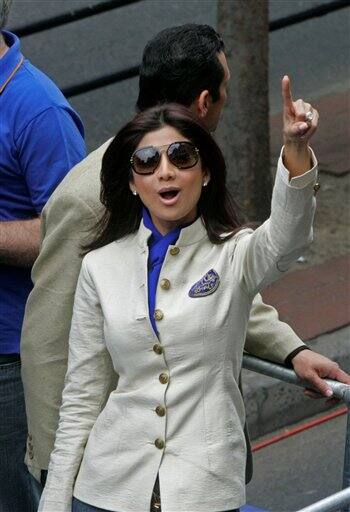 Bollywood actress Shilpa Shetty points from on top of the Rajasthan Royals team bus during a parade through the streets of Cape Town, ahead of the Indian Premier League Twenty20 cricket matches to be held over the weekend in Cape Town