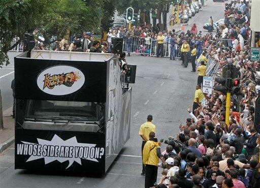 The Knight Riders cricket team drives past during a parade through the streets of Cape Town, ahead of the Indian Premier League Twenty20 cricket matches to be held over the weekend in Cape Town, South Africa.