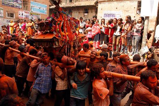 Locals of Thimi carry a chariot containing an image of a Hindu God around the city as they celebrate the Bisket Jatra Hindu festival on the outskirts in Katmandu, Nepal, Wednesday, April 15, 2009. During this festival.