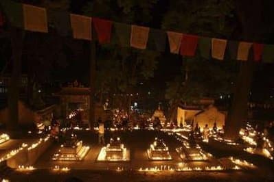 Devotees light candles in front of a Buddha statue to mark the Nepalese New Year 2066 at a temple in Kathmandu.