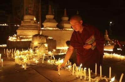 A nun lights a candle to mark the Nepalese New Year 2066 at a Buddhist temple in Kathmandu.