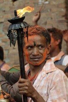 A man holds a torch during the second day of celebrations for Navavarsha, or the Nepalese New Year, at Thimi, in Kathmandu April 15, 2009. Navavarsha, which falls on April 14 this year, is a national holiday and people celebrate by carrying chariots of various Gods and Goddesses.