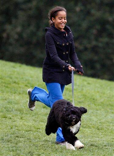 Malia Obama runs with new dog Bo a 6-month-old Portuguese water dog