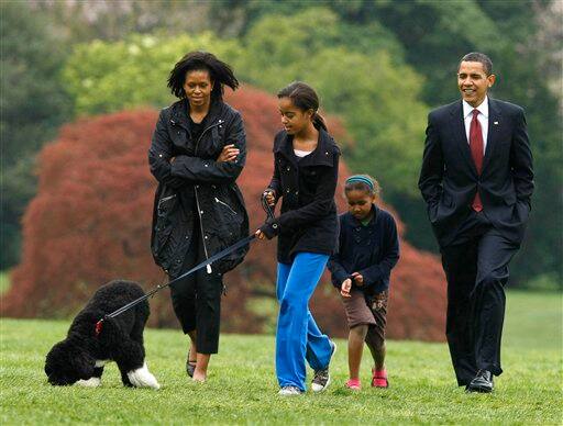 Malia Obama walks with their new dog Bo as President Barack Obama, first lady Michelle Obama and Sasha follow on the South Lawn of the White House