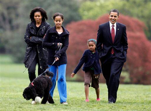 Malia Obama walks with new dog Bo, followed by President Barack Obama, Sasha Obama and first lady Michelle Obama on the South Lawn at the White House in Washington