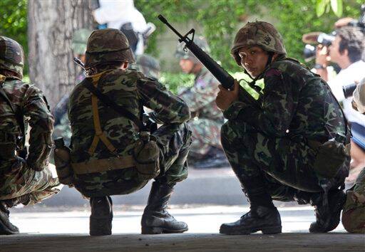 Thai soldiers take up defensive positions, in Bangkok, Thailand. Leaders of demonstrations that plunged the Thai capital into chaos said Tuesday that they were calling off their protests 