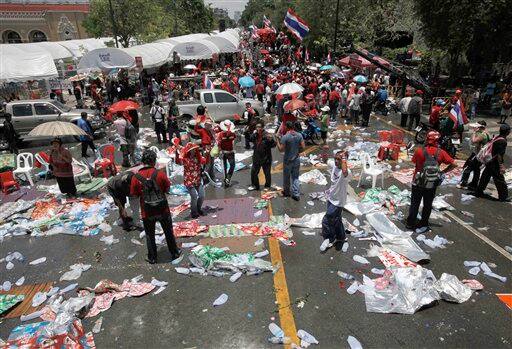 Thai anti-government protesters leave the stage area after leaders called off their rally outside the government house in Bangkok, Thailand