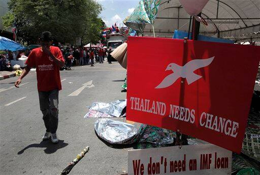 A Thai anti-government protester reacts after leaders called off their rally outside the government house in Bangkok, Thailand